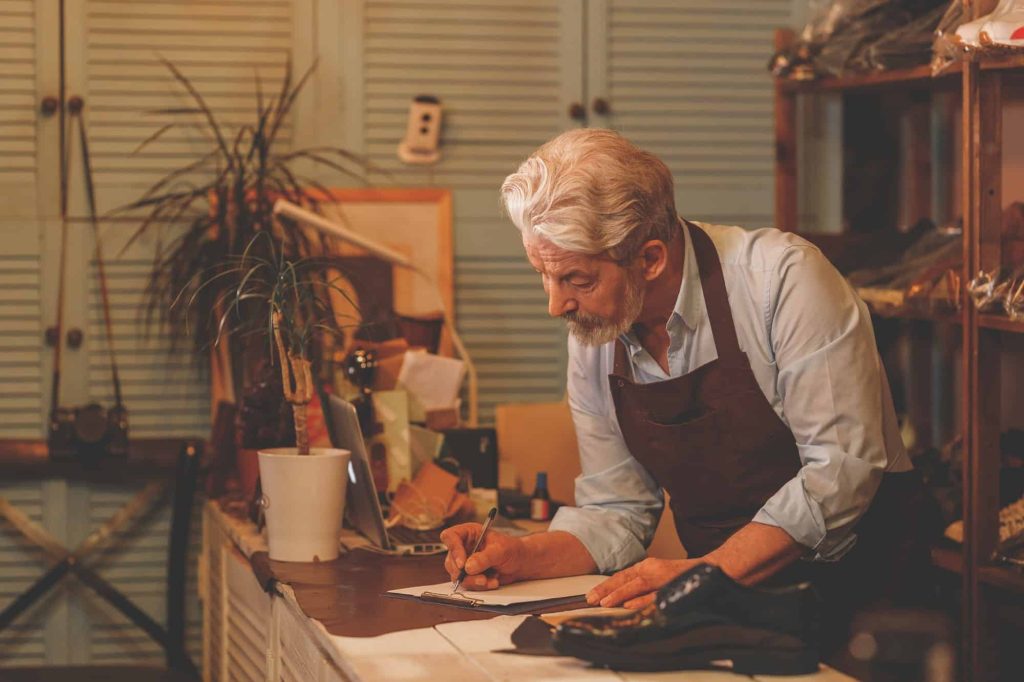 A senior man working in his home workshop